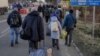 People fleeing the war in Ukraine arrive at the Romanian border at Siret, near the Ukrainian city of Chernivtsi, on February 24.