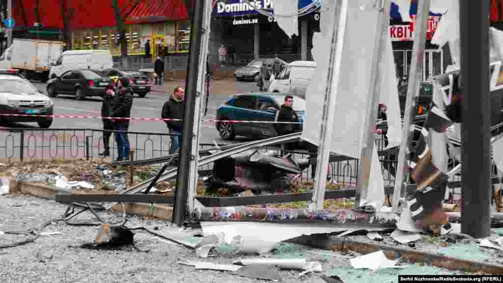 Debris is seen in Kyiv after a missile landed in a street.