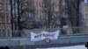 A sign hung on a bridge in St. Petersburg says, "No to war."