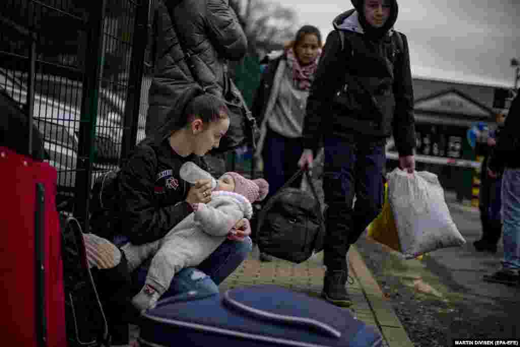 A woman feeds a child as people fleeing Ukraine arrive in Slovakia on February 25.
