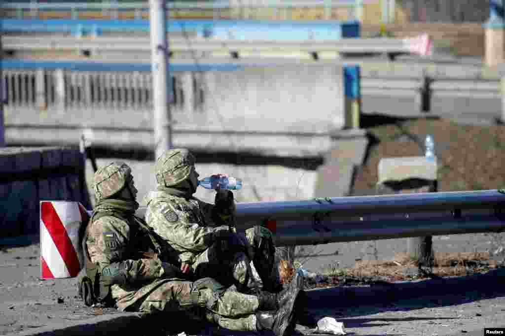 Ukrainian service members rest on the morning of February 26.