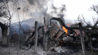 Smoke rises from an air-defense base in the aftermath of an apparent Russian strike on the Ukrainian city of Mariupol on February 24.