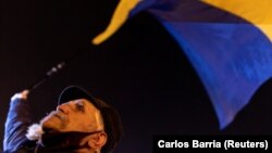 A man attends a rally in Mariupol to protest Moscow's decision to formally recognize two Russia-backed regions of eastern Ukraine as independent.