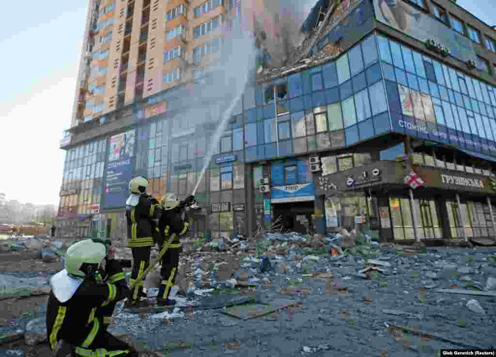Firefighters extinguish a fire at an apartment building in Kyiv.