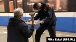 Workers from the Kyiv city subway system install a temporary water fountain for people to drink while seeking shelter from a possible Russian attack.