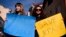 KOSOVO -- Women hold posters in support of Ukraine as they take part in a protest against the Russian invasion of Ukraine, in front of the Russian representative office in Pristina on February 25, 2022.