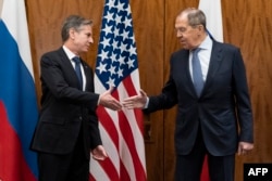 U.S. Secretary of State Antony Blinken (left) greets Russian Foreign Minister Sergei Lavrov before their meeting in Geneva on January 21.
