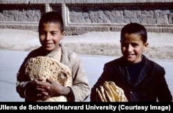 Children with freshly baked flatbread in Isfahan.