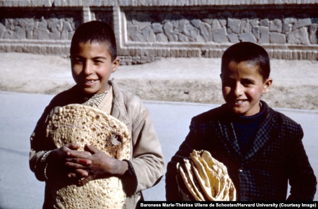 Children with freshly baked flatbread in Isfahan.