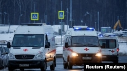 Ambulances park outside a hospital for COVID-19 patients on the outskirts of Moscow. 