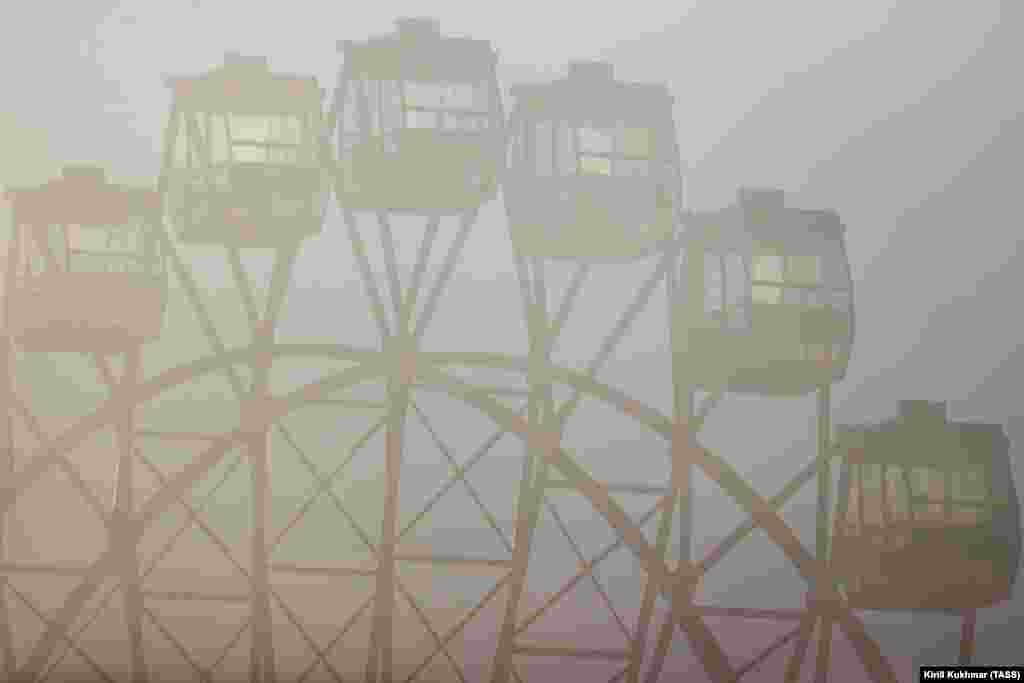 Smog hangs over a Ferris wheel on Mikhailovskaya Embankment in the Russian city of Novosibirsk.&nbsp;