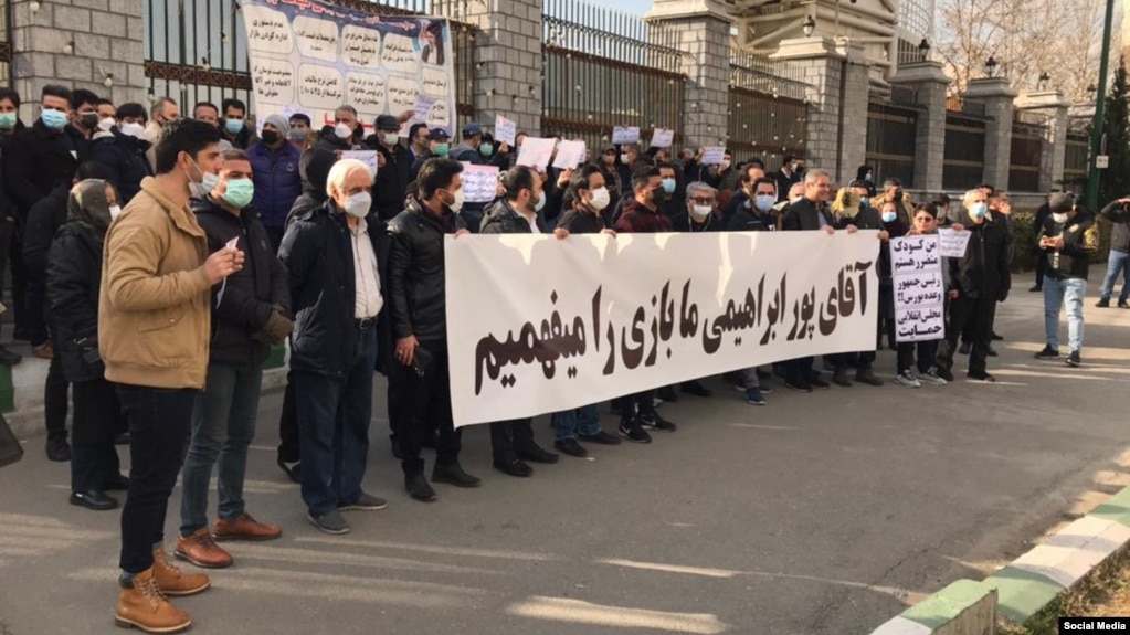 After suffering losses in recent months amid Iran's crumbling economy, shareholders protested outside the parliament building in Tehran on January 20.