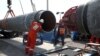 Workers are seen at a construction site of the Nord Stream 2 gas pipeline, near the town of Kingisepp, Russia, in June 2019. The pipeline is completed but had not yet begun operating while it waited for certification from German regulators.