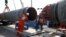Workers are seen at a construction site of the Nord Stream 2 gas pipeline, near the town of Kingisepp, Russia, in June 2019. The pipeline is completed but had not yet begun operating while it waited for certification from German regulators.