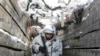 UKRAINE -- An armed serviceman walks along a trench on the territory controlled by pro-Russian militants on the frontline with Ukrainian government forces near Spartak village in Yasynuvata district of Donetsk region, eastern Ukraine, Thursday, Jan. 27, 2