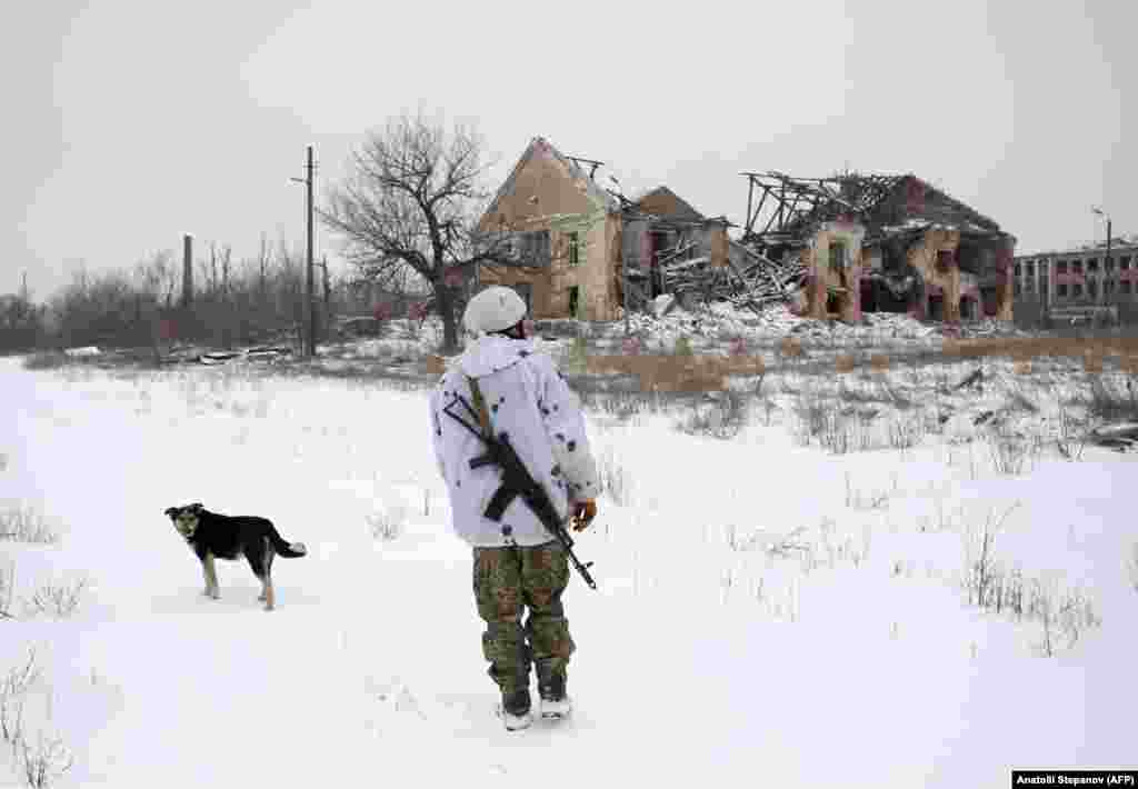 A Ukrainian soldier passes in the war-damaged village of Pesli, close to the front line with the separatists in eastern Ukraine.