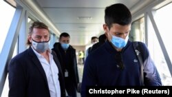 Serbian tennis player Novak Djokovic (right) arrives at Nikola Tesla Airport in Belgrade on January 17. 