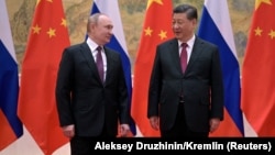 Russian President Vladimir Putin (left) attends a meeting with Chinese President Xi Jinping in Beijing on February 4.