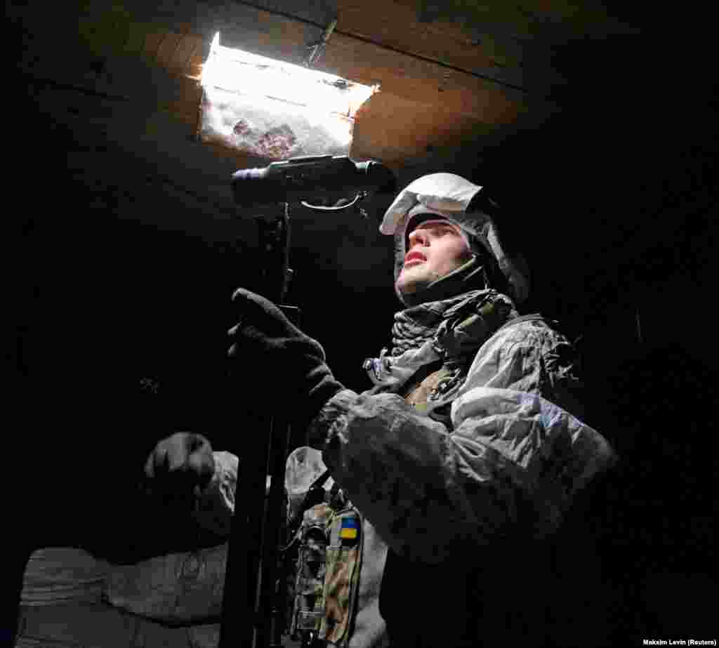 A Ukrainian fighter looks out from a frontline position near Avdiyivka on January 25.&nbsp;