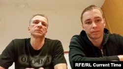 Father and son Vital and Uladzislau Kuznechyk jumped over the Swedish Embassy's fence in Minsk to evade arrest after joining mass protests against election fraud. (video grab)