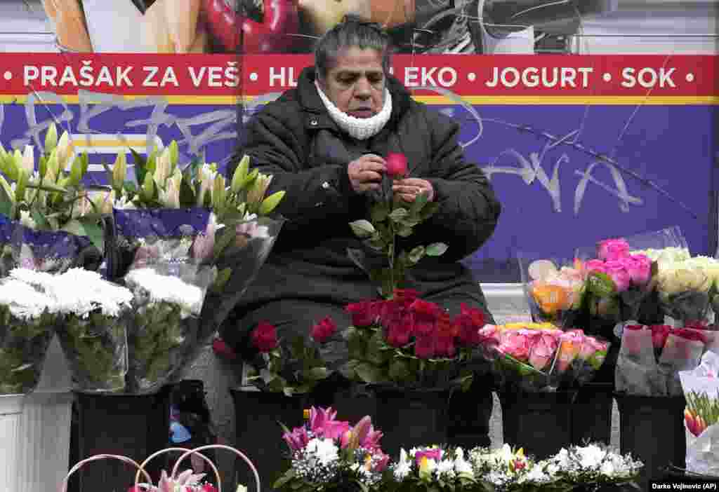 A woman sells flowers in downtown Belgrade.