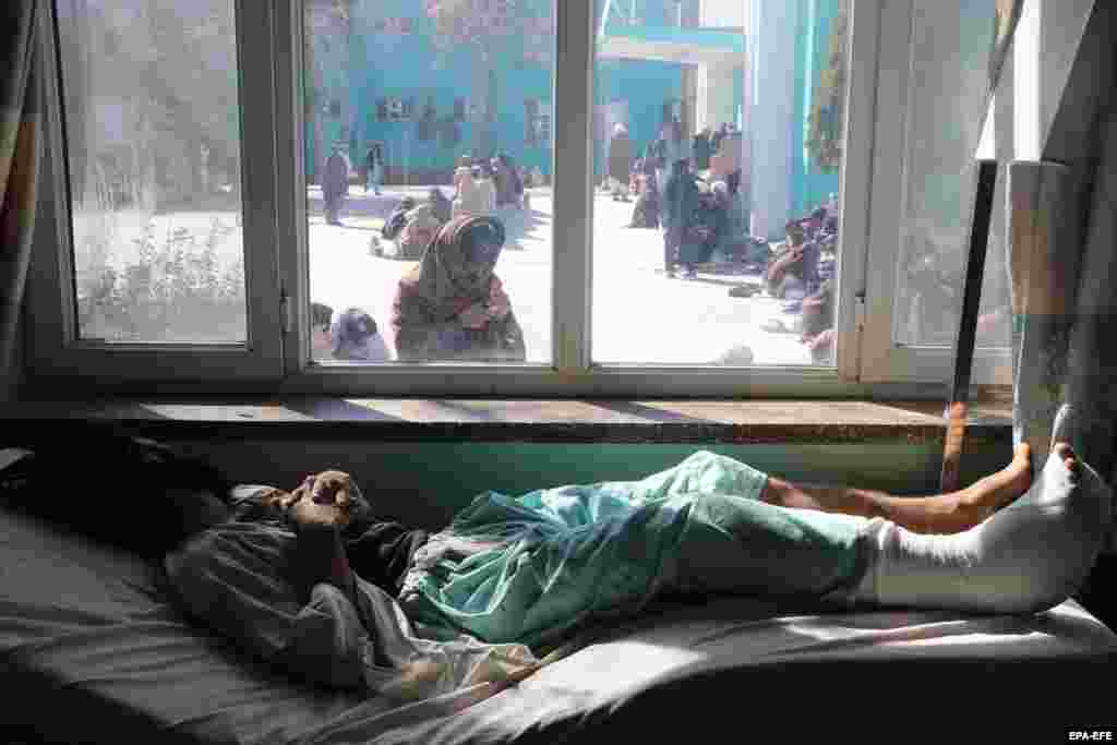 An Afghan man who was injured in a road accident receives medical treatment at a hospital in Kandahar.