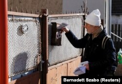 Volunteer Peter Nogradi distributes NTI newsletters in Dunabogdany, a town around 35 kilometers north of Budapest.