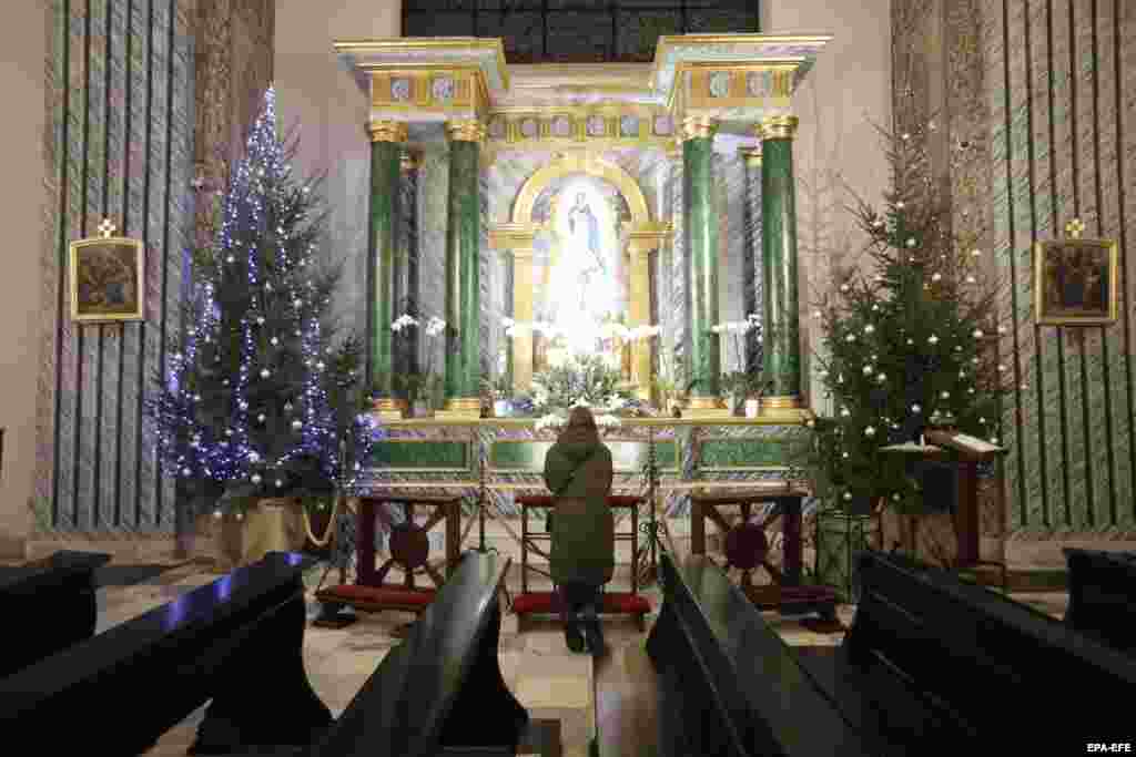 A woman during a &quot;day of prayer&quot; for peace in the St. Alexander Roman Catholic church in Kyiv on January 26.&nbsp;