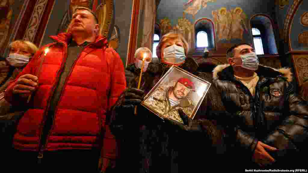 Relatives of a Ukrainian serviceman killed in combat attend a memorial service inside St. Michael&#39;s Golden-Domed Monastery in Kyiv on January 21.&nbsp; &nbsp; 