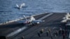 This US Navy handout photo released on May 12, 2026, by US Central Command Public Affairs shows an F/A-18E Super Hornet, attached to Strike Fighter Squadron 151, and an EA-18G Growler, attached to Electronic Attack Squadron 133, launching from the flight 