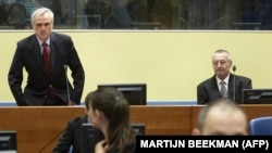 Serbia's former secret police chief Jovica Stanisic (left) and his former deputy Franko Simatovic (right) sit in the court prior to the trial chamber judgement hearing at the International Criminal Tribunal for the former Yugoslavia in The Hague on May 30, 2013.