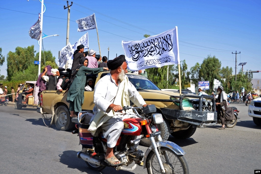 Taliban members participate in a parade in the southern Afghan city of Kandahar on August 31 to mark the first anniversary of the withdrawal of US-led troops from Afghanistan.