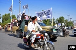 Taliban members participate in a parade in the southern Afghan city of Kandahar on August 31 to mark the first anniversary of the withdrawal of US-led troops from Afghanistan.