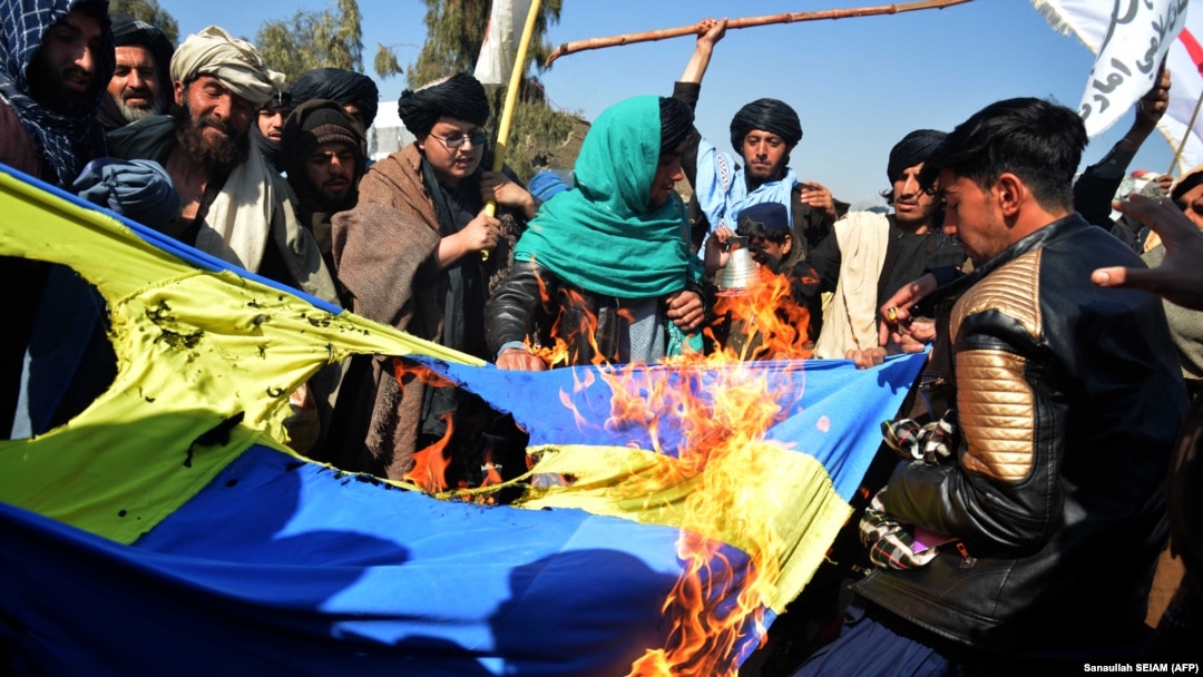 Protesters burn a Swedish flag during a demonstration in Kandahar on January 25. The demonstration followed the burning of a Koran by a far-right politician in Stockholm. In June, an Iraqi immigrant also burned a Koran outside a Stockholm mosque.