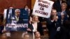 Members of the Serbian parliament hold up a banner reading, "Vucic, you betrayed Kosovo," during a special session in Belgrade on February 2.