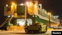 A Ukraine-bound Bradley fighting vehicle proceeds to load onto a carrier in North Charleston, South Carolina, on January 25.