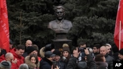 People take photos of a bust of Soviet leader Josef Stalin after it was unveiled in Volgograd in February 1. 