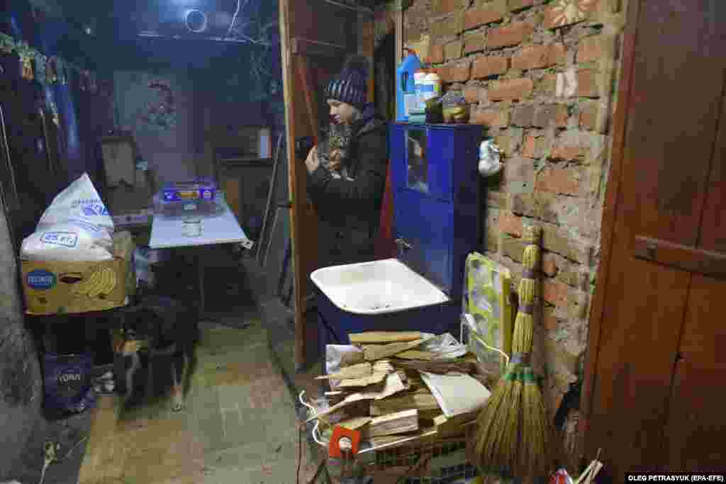 With temperatures hovering around freezing, the government and humanitarian groups have brought in stoves and distributed wood to families. Evelina is among an estimated 700 children living in Lyman. She&nbsp;lives with her mother, grandmother, and four neighbors in this basement.