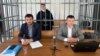 Zarema Musayeva (center) in a defendant's cage in a court in Grozny earlier this year. 