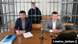 Zarema Musayeva (center) in a defendant's cage in a court in Grozny earlier this year. 