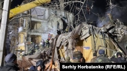 Ukrainian rescuers work at the site of a destroyed apartment building in Kramatorsk after it was hit by a Russian air strike on February 1.