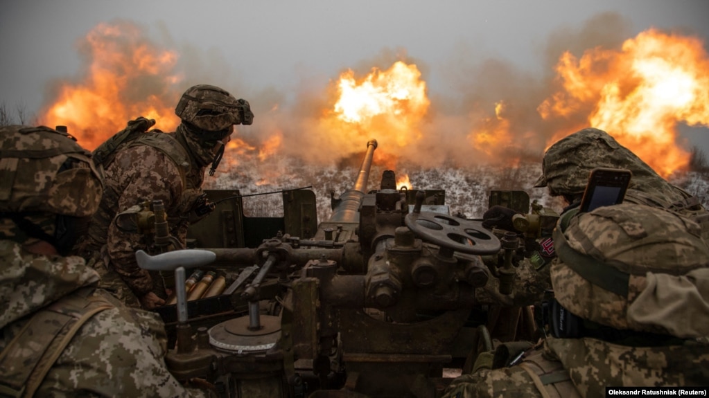 Ukrainian soldiers fire an antiaircraft gun toward Russian positions on a front line near the town of Bakhmut in Ukraine's Donetsk region on January 15.