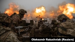 Ukrainian soldiers fire an antiaircraft gun toward Russian positions on a front line near the town of Bakhmut in Ukraine's Donetsk region on January 15.