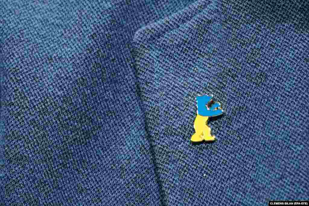The Berlinale film festival&#39;s artistic director wears this year&#39;s Berlinale pin in the national colors of Ukraine during the press conference of the 73rd Berlin International Film Festival.