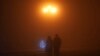 A couple walks in the fog in Stepanakert, the biggest city of Nagorno-Karabakh, a largely ethnic Armenian breakaway region of Azerbaijan, on December 15, 2022. This was at the beginning of the blockade in the Lachin Corridor, the only land connection between this area and Armenia.&nbsp;