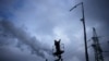 An electrician checks damage at a power plant after a rocket attack in Kyiv on January 26.