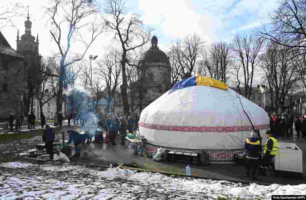 A yurt is erected in the western Ukrainian city of Lviv on February 1. A Kazakh yurt was first set up in Bucha, near Kyiv, in early January. The shelter offered food and a warm space for locals to mingle. The Kazakh volunteers behind the initiative promised to erect more of the shelters in other Ukrainian cities.