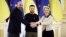 Ukrainian President Volodymyr Zelenskiy (center) European Commission President Ursula von der Leyen (right) and European Council President Charles Michel shake hands during their EU-Ukraine summit in Kyiv on February 3. 