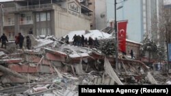 TURKEY - Rescuers carry out a person from a collapsed building after an earthquake in Malatya, February 6, 2023. 