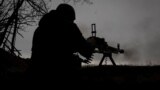 UKRAINE – A Ukrainian soldier on the front line fires a machine gun at the positions of the Russian army near the city of Soledar, Donetsk region, January 14, 2023